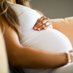 Pregnant woman with hands on stomach